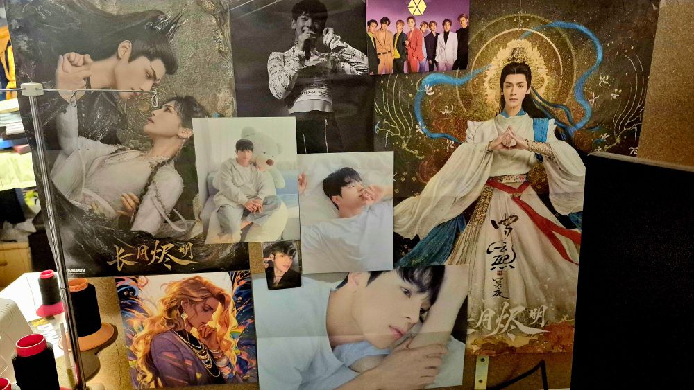Posters of Kim Woojin, Luo Yunxi, Exo on a wall