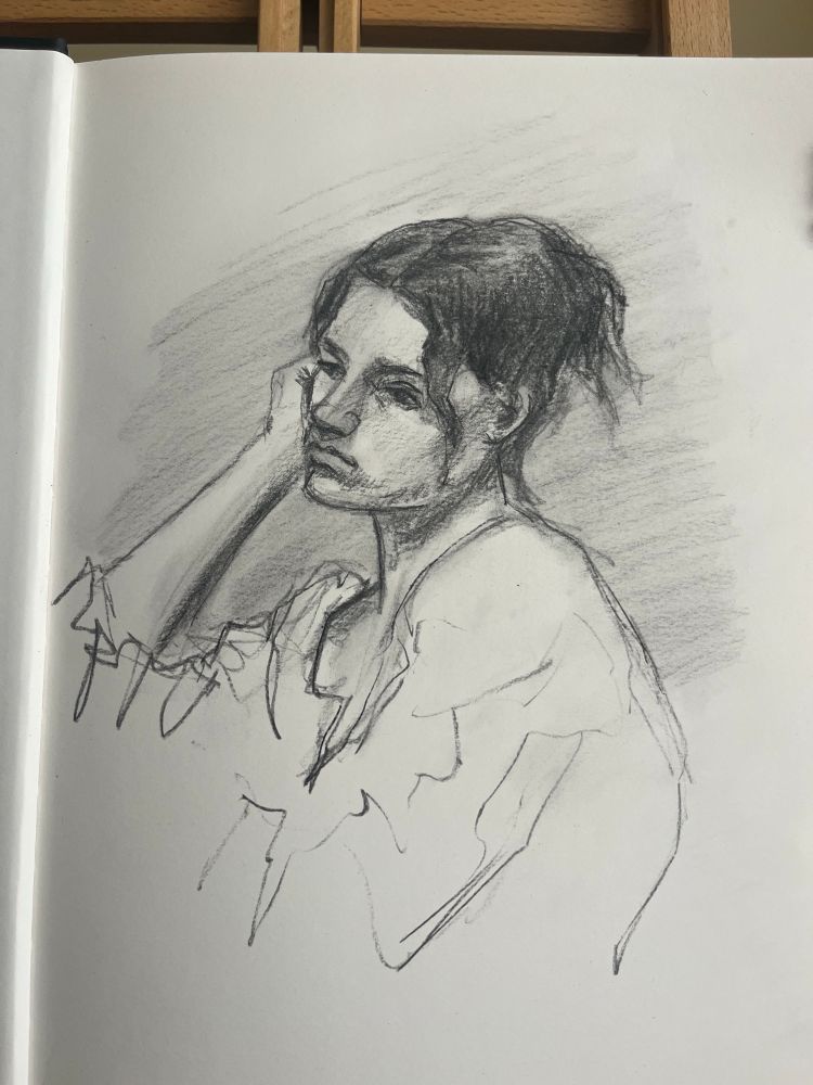 Charcoal sketch of a woman resting her cheek on her hand
