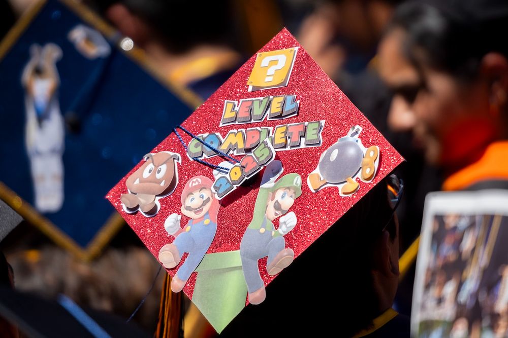 A red graduation cap featuring Mario characters. (Photo by Adam Lau / Berkeley Engineering)