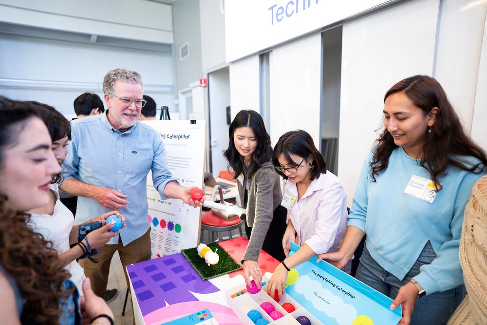 Attendees gather around a booth for a project on “The storytelling caterpillar.” (Photo by Adam Lau / Berkeley Engineering)