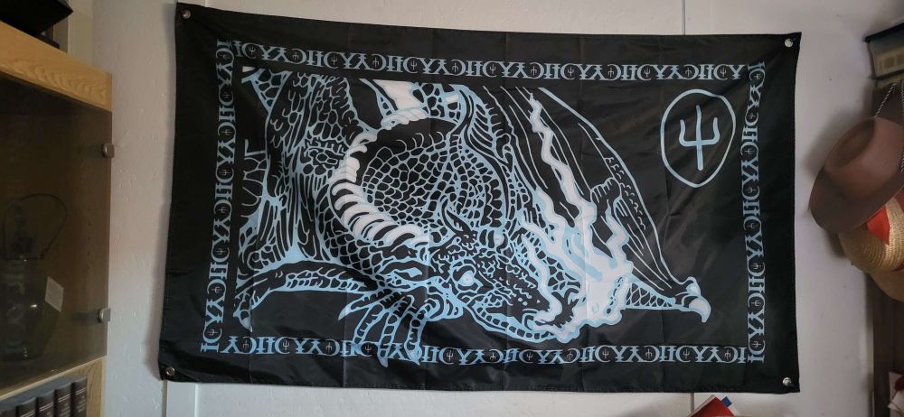 black and cyan scaled and icy twenty one pilots flag displayed on white wooden wall