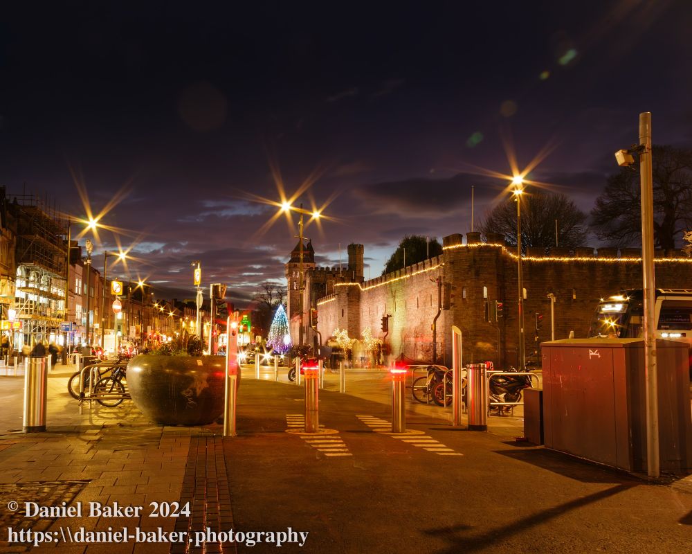 Cardiff Castle at night with Christmas lights viewed from across the street