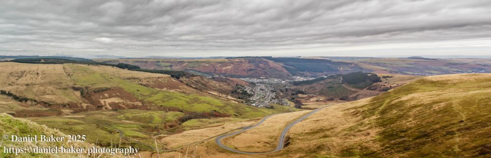 panorama from a mountain looking down with a town visible