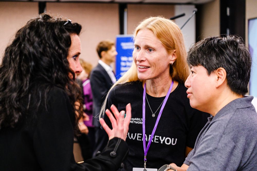 ID: Close up image of Dentons' Belinda May in deep, animated conversation with Hillary Regan and Jean Co of MSD, listening intently to her thoughts at our Global Summit.