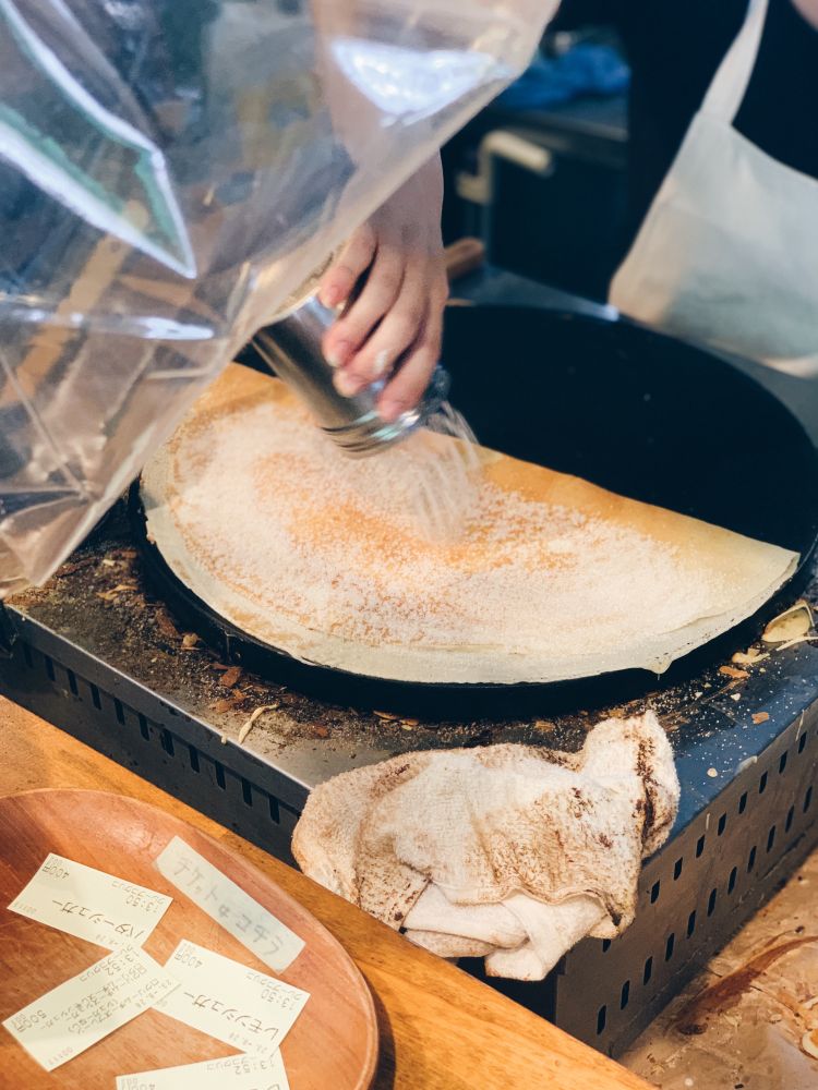 クレープにシュガーをかけているところ。