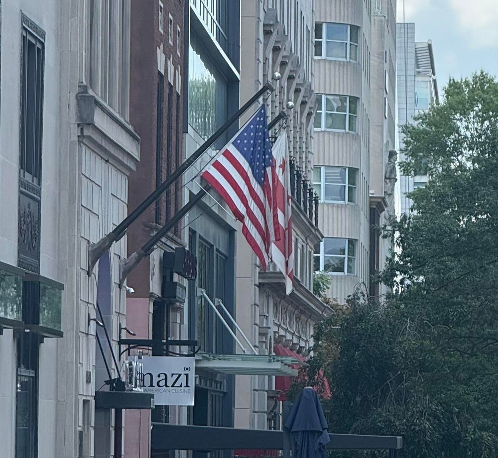 A photo of a sign for a restaurant.  Because it has been partially obscured, it reads “nazi”. 