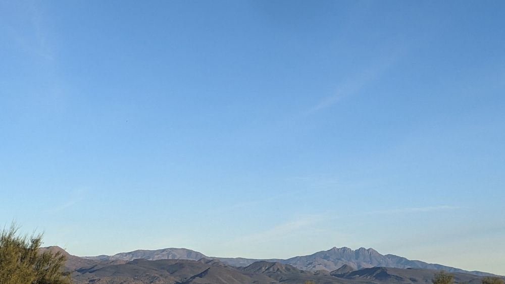 Four Peaks mountain range in Arizona with desert landscape under blue sky