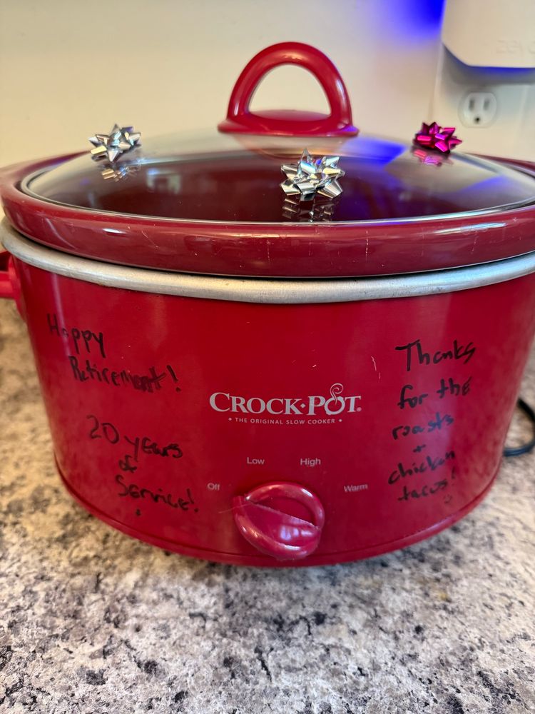 Imagine of a crock pot with bows on it and messages thanking it for 20 years of service and a happy retirement.  