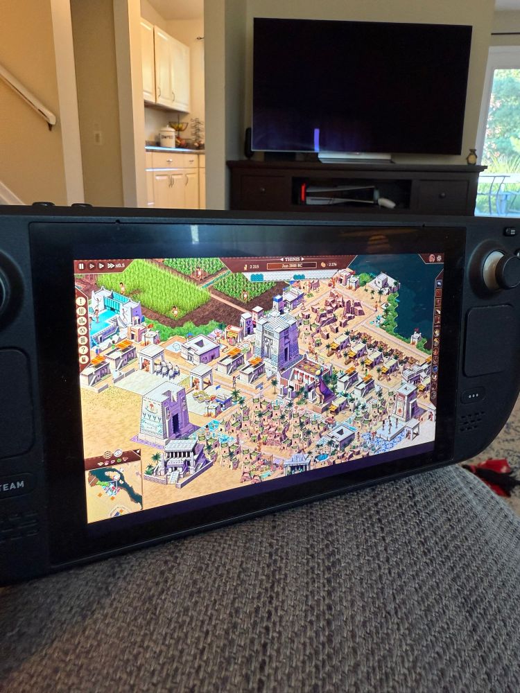 A Steam Deck showing gameplay from Pharaoh: A New Age. 
