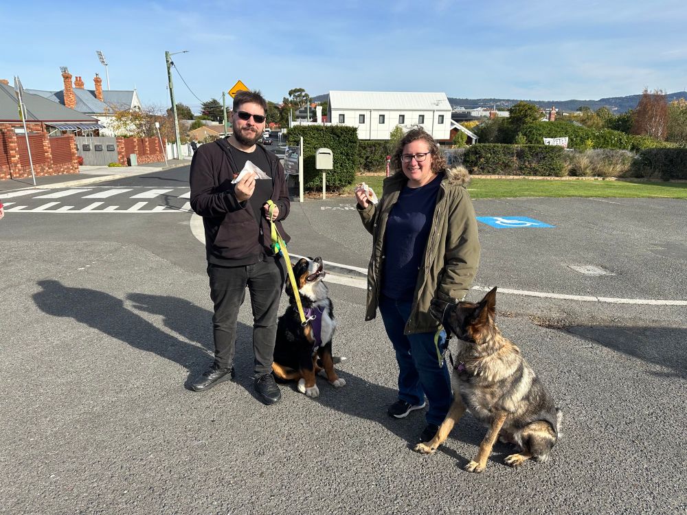 Myself, Clare and the dogs Maru and Argus holding democracy sausages 