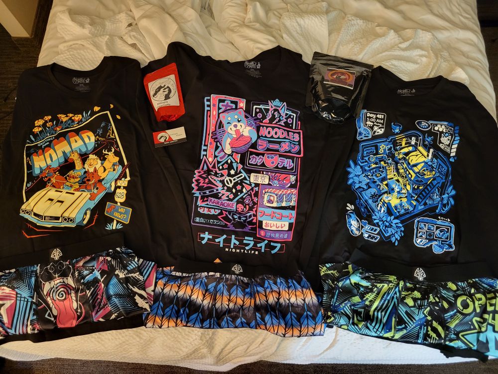 Saybins haul from Nomad Complex, Entropy Elixirs! Various colorful shirts and boxers are arranged on a bed, with bags of coffee Inbetween.

Colorful boxers line the bottom row!
