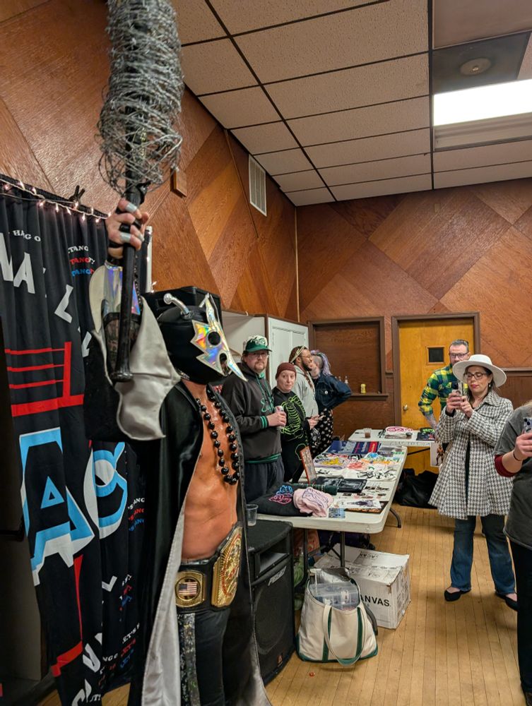 Ultramantis Black entering with a bat wrapped in barbed wire.