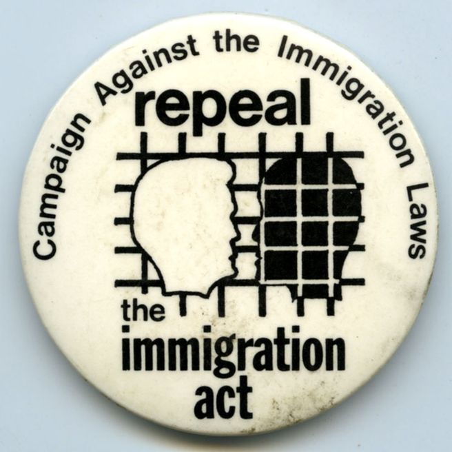White badge with black text that reads, "Repeal the Immigration Act" in the middle of the badge, with the name of the organisation, Campaign Against Immigration Laws around the edge of the badge.