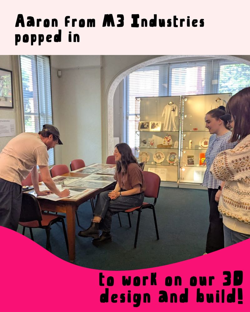 A picture of Aaron, Belinda (Library Manager), and some of our volunteers in the NALGO Room, talking about the exhibition. The caption reads: "Aaron from M3 Industries popped in to work on our 3D design and build!"
