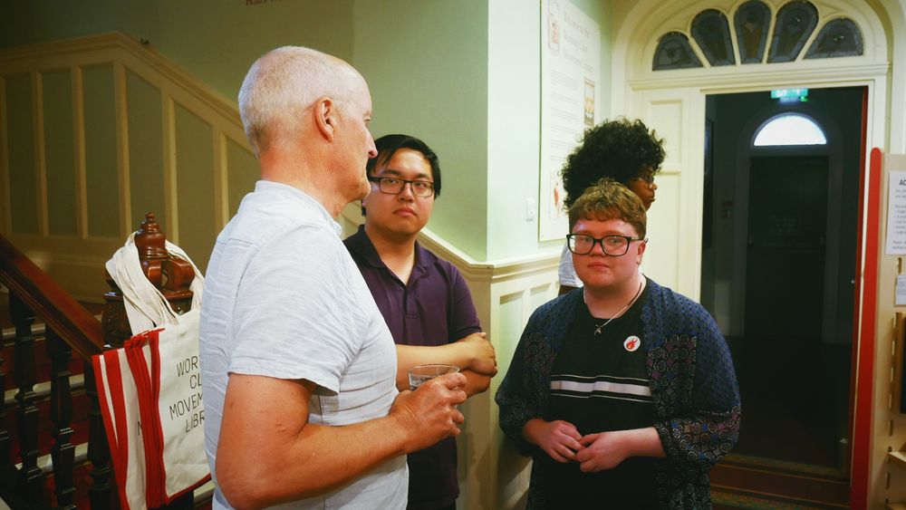 An ex Big Flame member speaks to two of the Little Flames group.