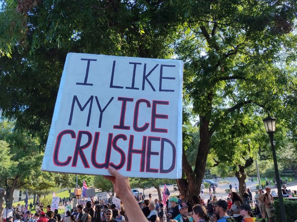 Protest sign reads: I like my ICE crushed
