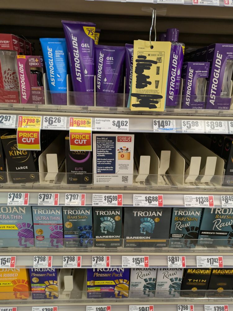 A flyer tucked in front of a display of condoms
