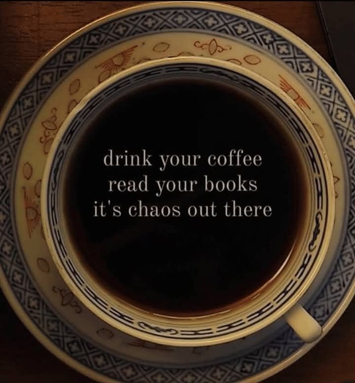 A cup of coffee with the text: drink your coffee read your books it's chaos out there 