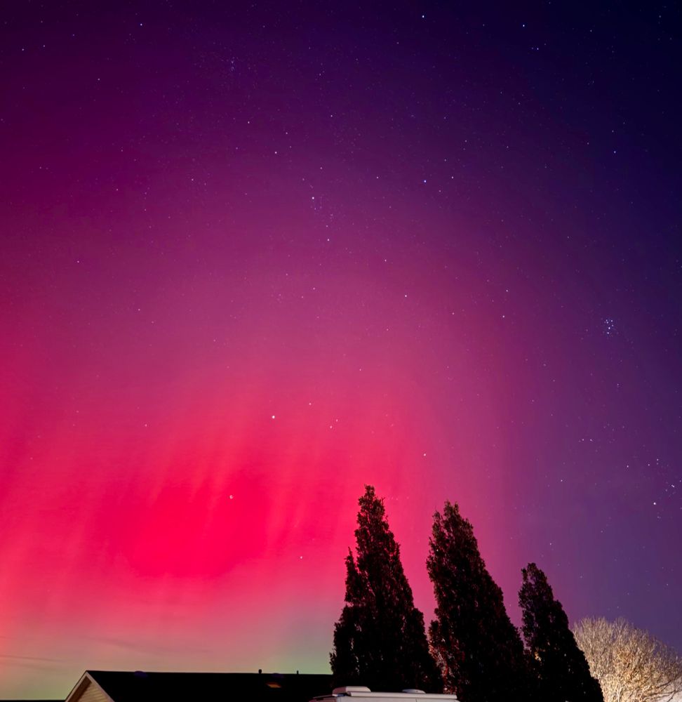 A bright red and green aurora as seen above the northeast horizon, from Northern Colorado, about an hour after sunset. 11/11/25 