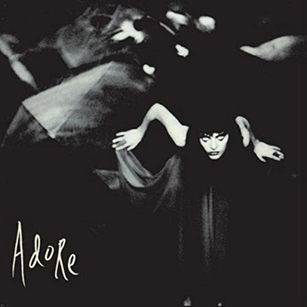 Cover of the Smashing Pumpkins Album adore. Mysterious goth girl on the right hand side, "Adore" in the bottom left corner.