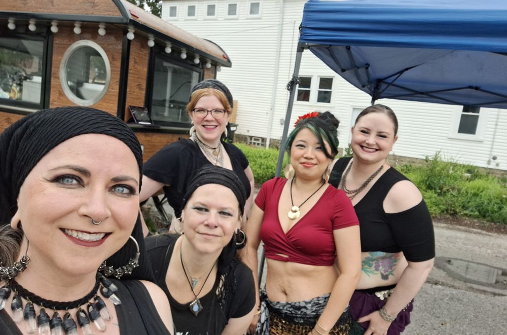 Five bellydancers pose before a show.