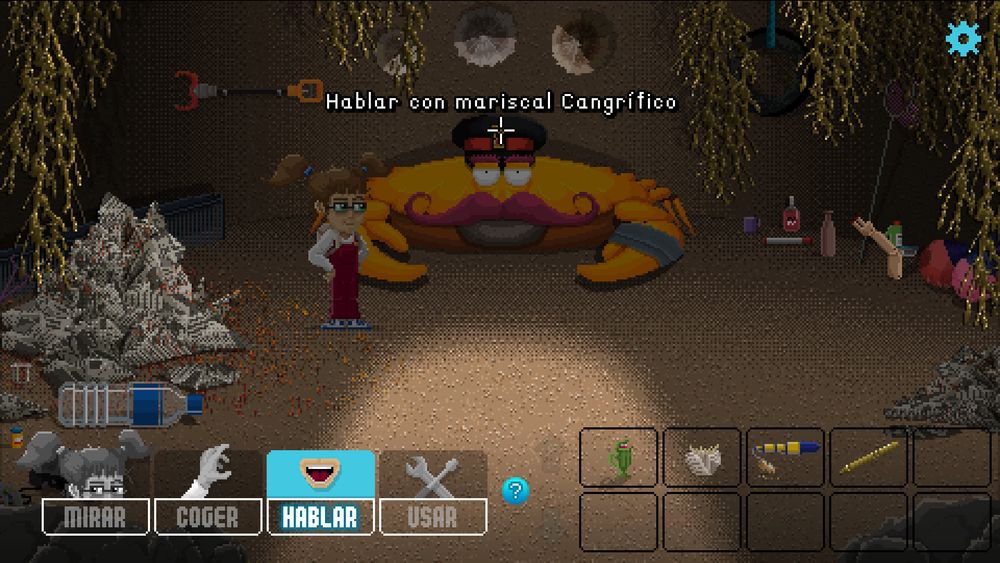 Lucy, una niña con gafas, coletas, un peto y gafas, está en la guarida de un cangrejo gigante que colecciona todo tipo de objetos. El cursor está sobre el cangrejo y la etiqueta pone "Hablar con mariscal Cangrífico".