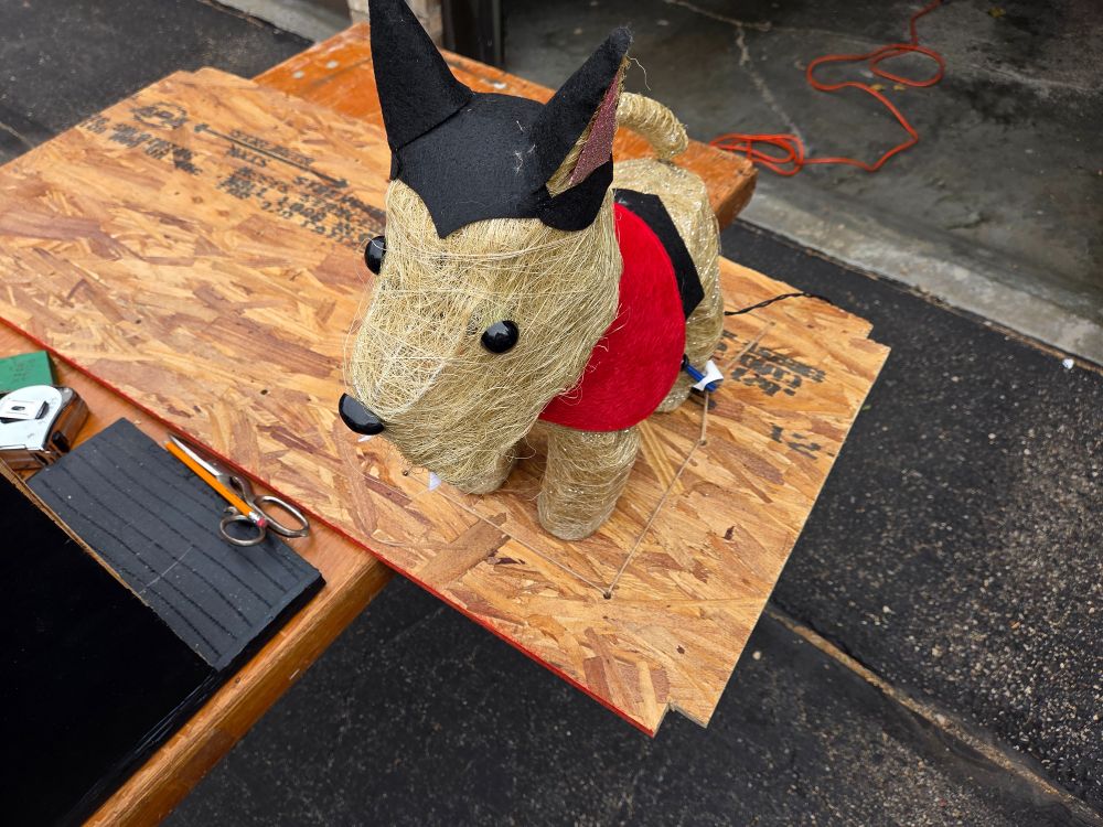 the vampire dog anchored to the plywood
