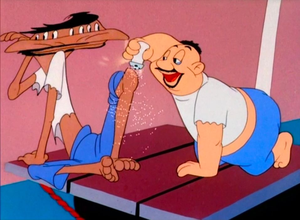 Man putting salt on friend's knee while on a raft at sea. 