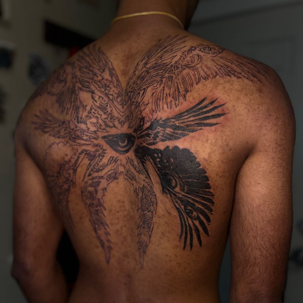 An unfinished back tattoo of a biblically-accurate angel