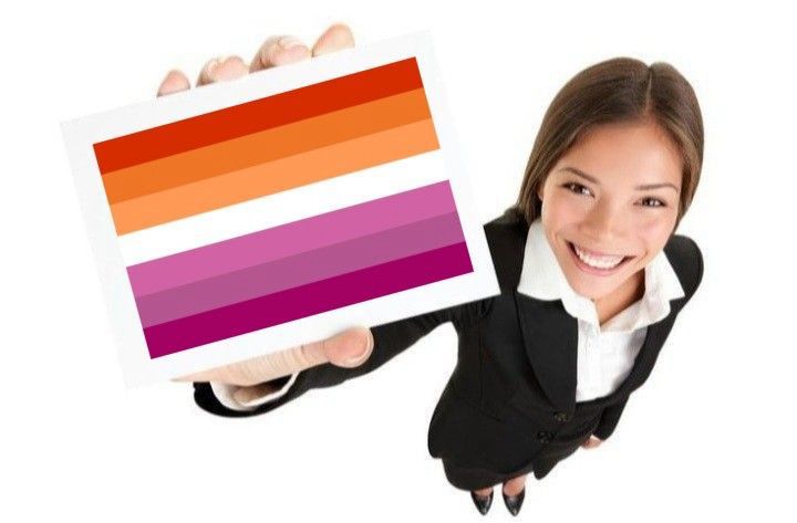 stock image of a woman holding up a card but the lesbian flag superimposed on it 