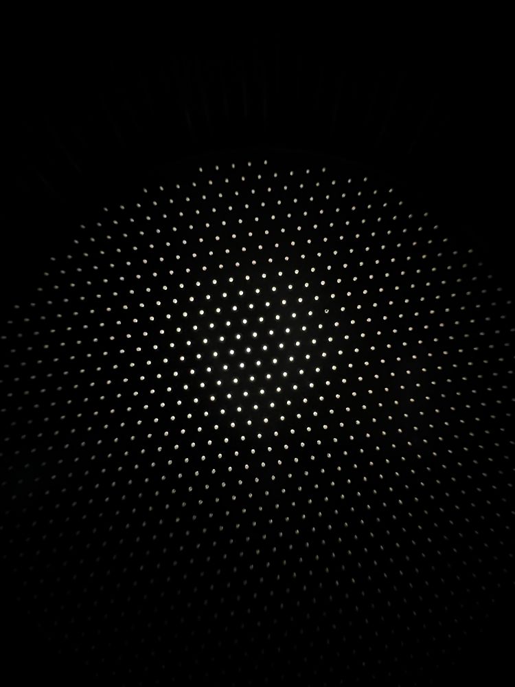The bottom of another basket, the holes go all the way to the edge in this case. There are a lot more holes, but they’re smaller.
