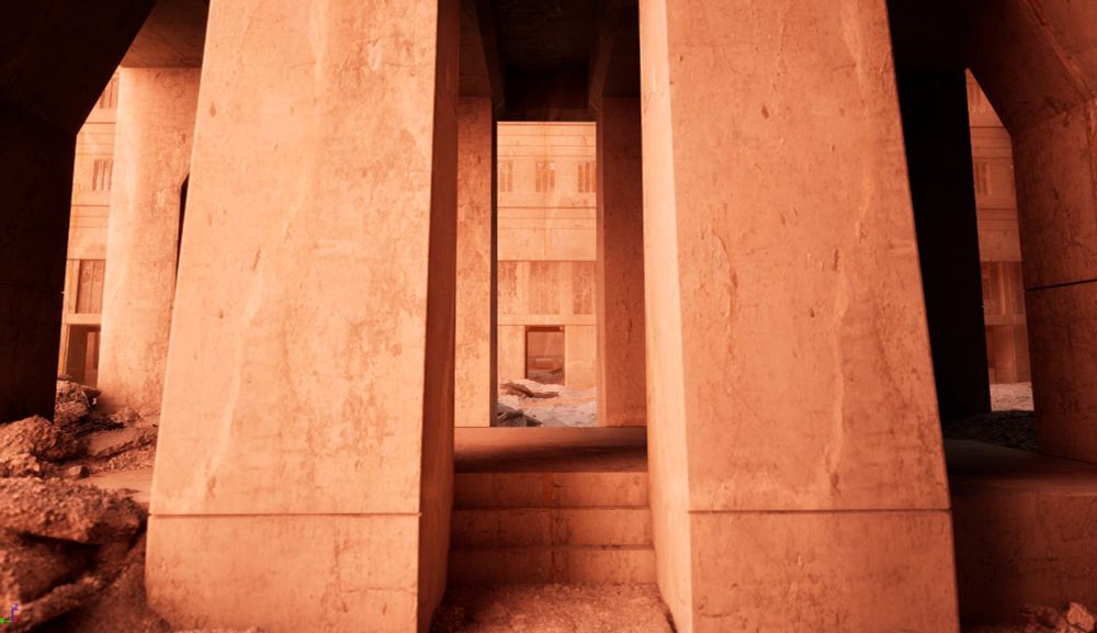 looking through an alley of brutalist architecture. just ahead is a stairway leading into a building.