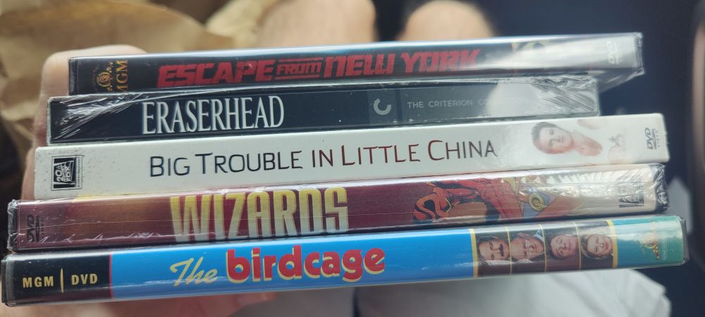 DVD boxes for Escape from New York, Eraserhead, Big Trouble in Little China, Wizards, and The Birdcage