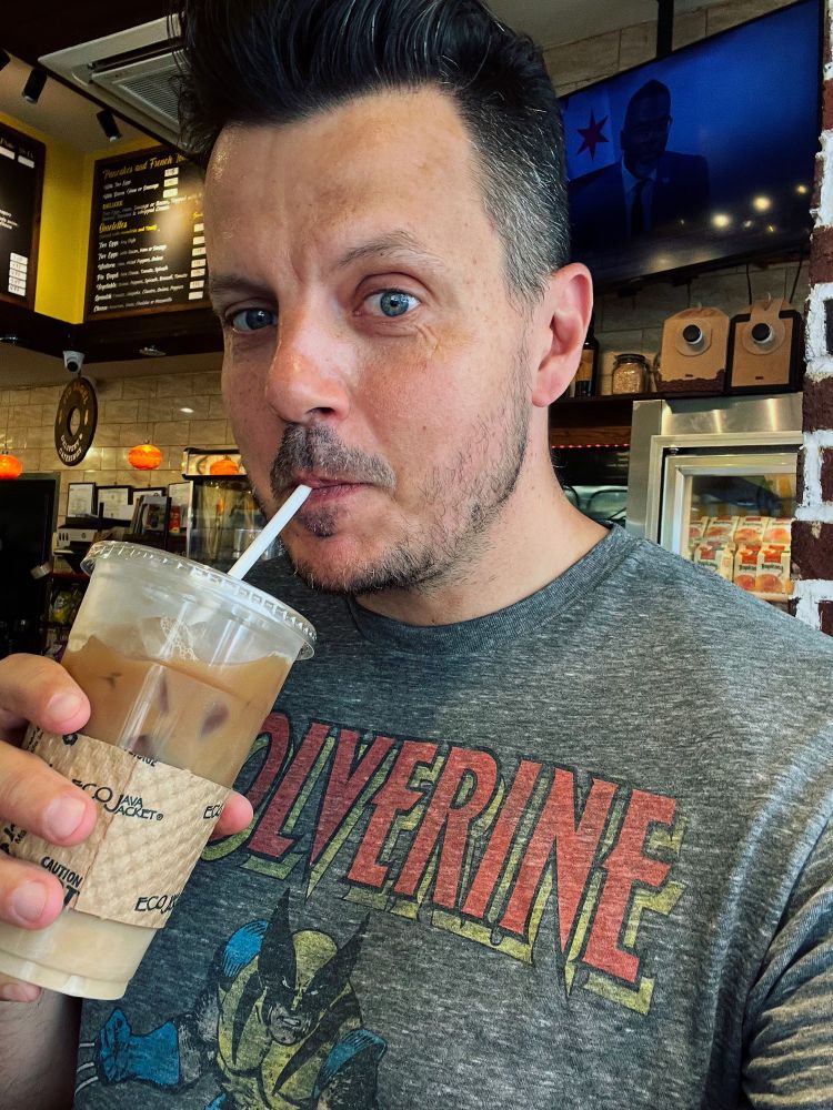Picture of me drinking ice coffee wearing a Wolverine t-shirt.