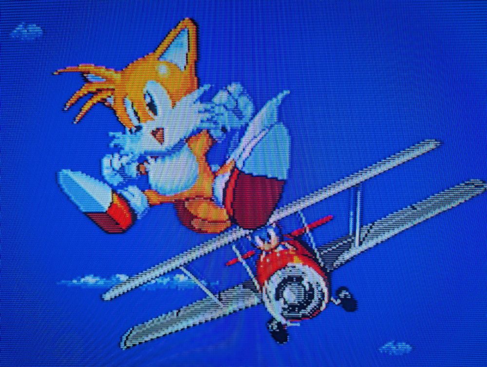 The ending scene for Sonic 2 when playing as Tails.

Tails is jumping into the sky victoriously as Sonic is in the Tornado ready to catch him.

They did it!
