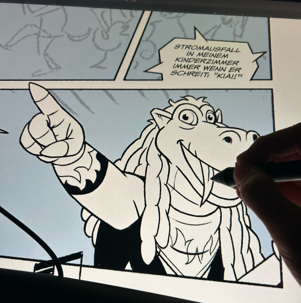 Hand & pen on a pen tablet screen drawing a cartoon dragon in a heavy metal outfit 