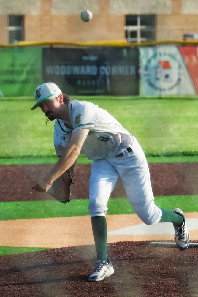Pitcher throwing a high arching ball