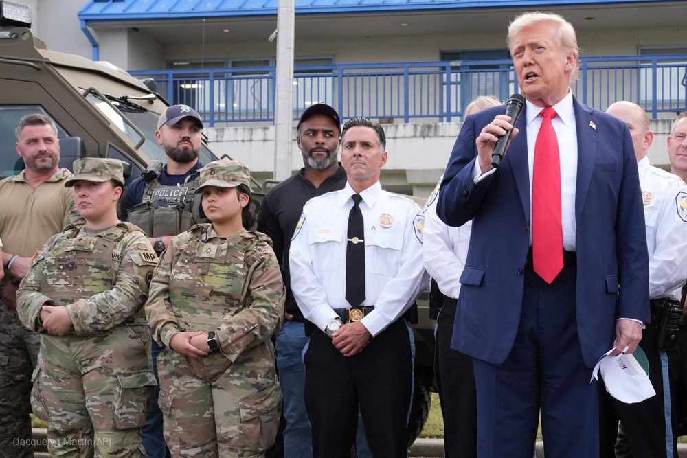 President Donald Trump speaks with members of law enforcement and National Guard soldiers in Washington.