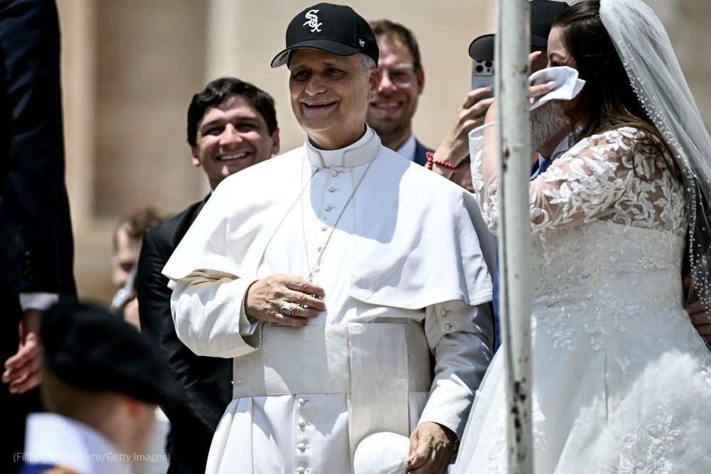 Pope Leo XIV reacts wearing a Chicago White Sox baseball team cap as he meets newly wedded couples during the weekly general audience in St Peter's Square at the Vatican on June 11, 2025. Photo by Filippo Monteforte for Getty Images.