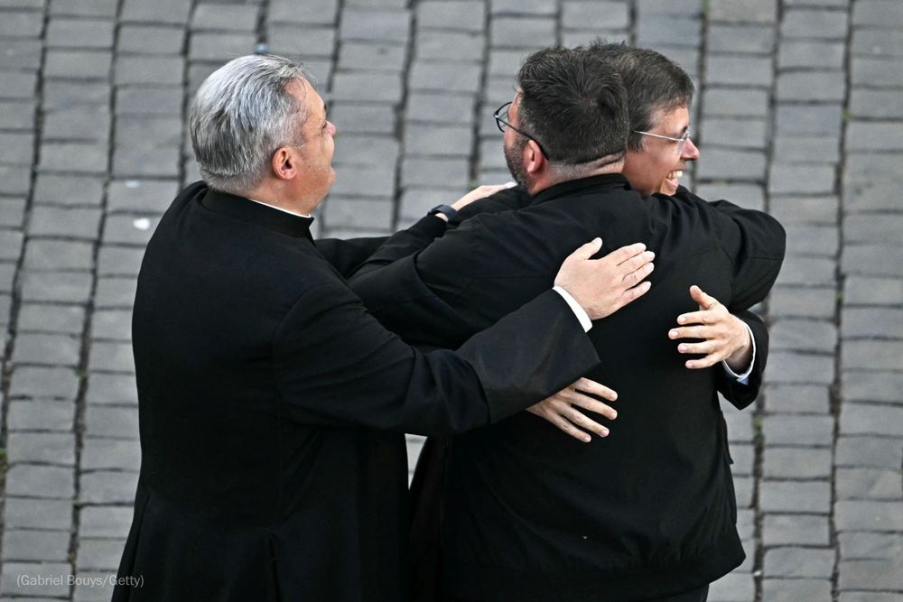 Prelates celebrate on St Peter's Square as cardinals signaled they elected a new pope during their conclave in the Vatican on May 8, 2025. Photo by Gabriel Bouys for Getty Images.