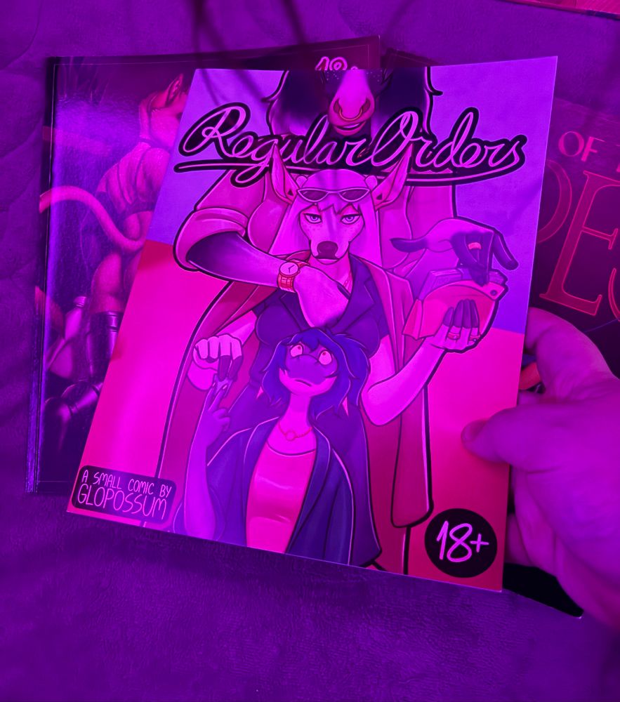 A photo of 3 18+ comics made by the artist Glopossum, named Crossing That Bridge, left, and A Show of the Ropes, right, with the latest one I just obtained, named Regular Orders, shown off front and center.