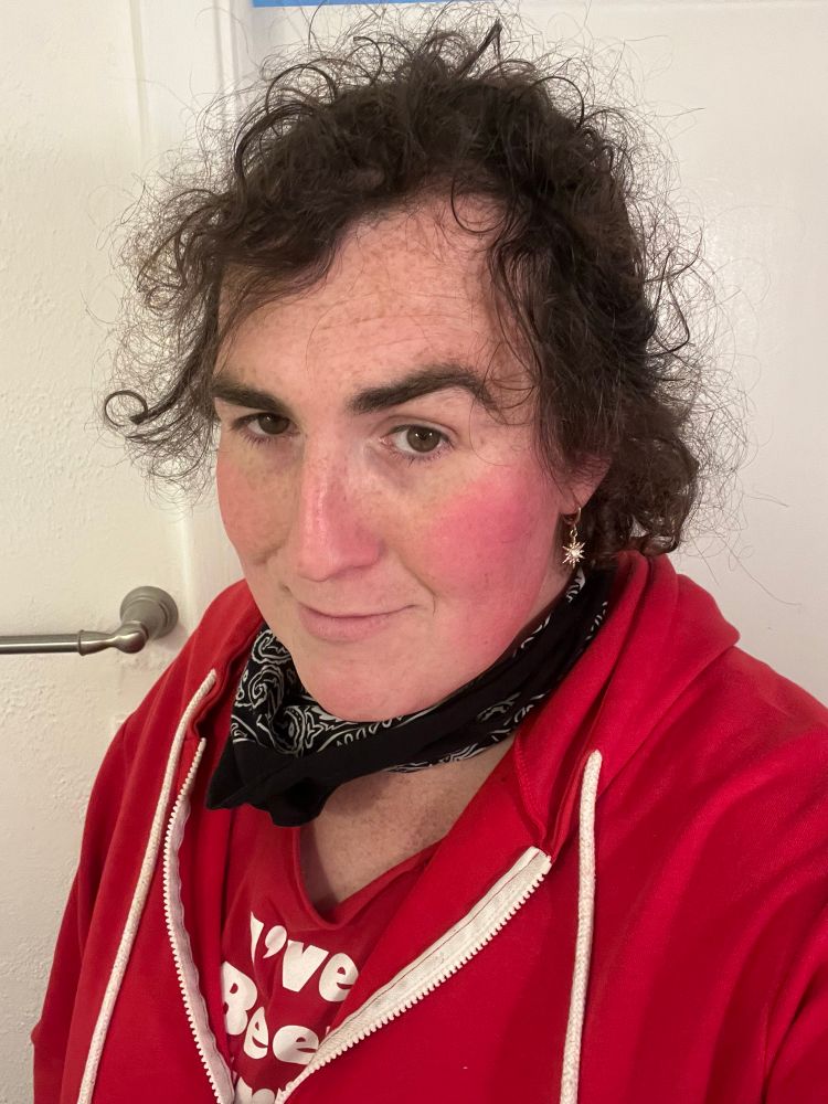 Knife mommy in a red hoodie and red Stereolab T-shirt and black bandana 