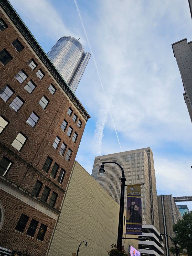 Photo of the downtown Atlanta Westin peeking out from behind brick and concrete buildings