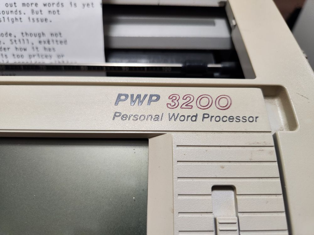 A personal word processor. Like a cross between a computer and a typewriter. Close up of name