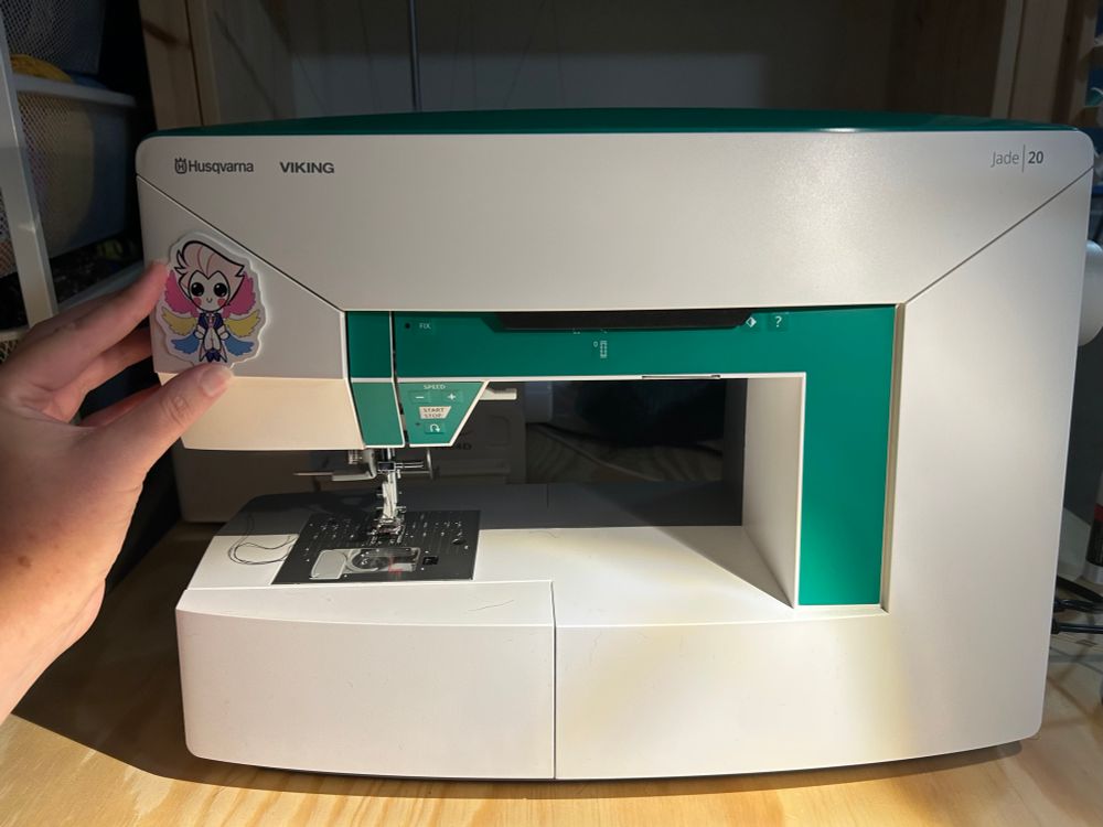Me figuring out the best spot to place one of the stickers on my sewing machine. I’ve had the idea to cover it in fandom stickers for a little while now, but this will be the first to bless my sewing endeavors!
