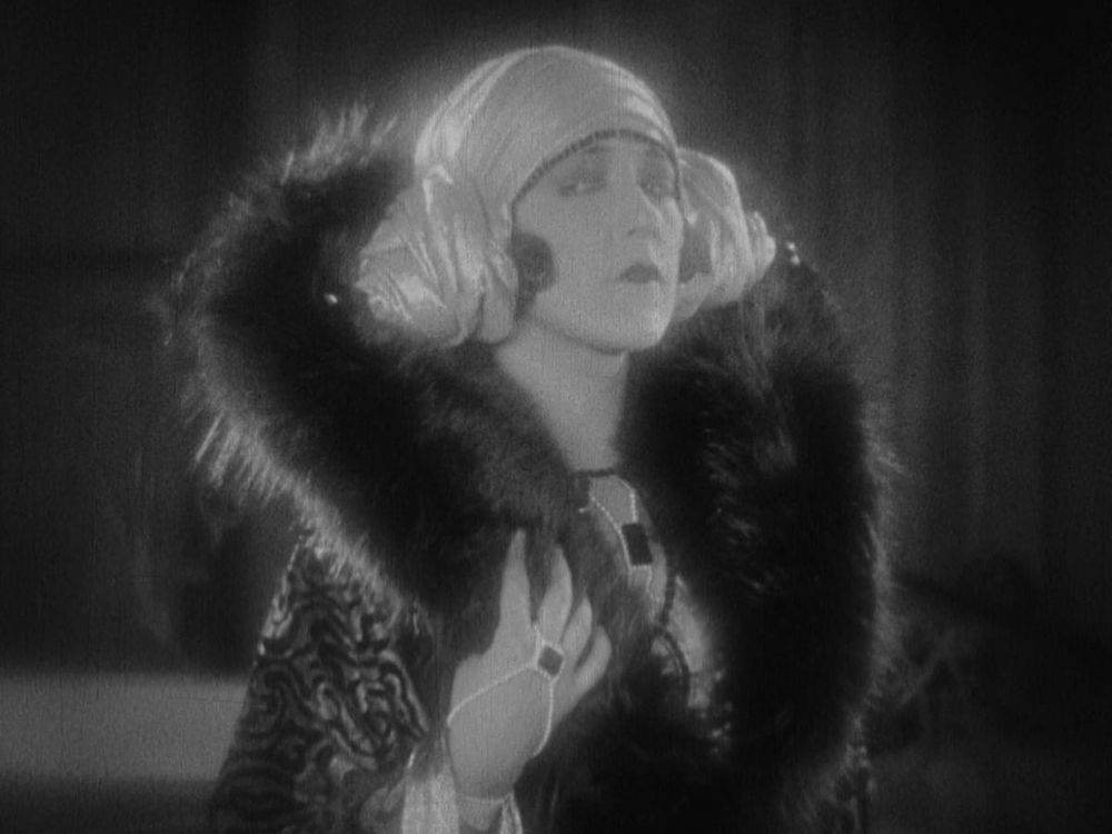 Aileen Pringle in (you guessed it!) "The Mystic" in a fur coat with an almost parodically large helm (which is the part of the outfit I do NOT endorse - fur is murder kids) ans a gold lame headdress that calls to mind Carrie Fisher's hair in the OG "Star Wars" trilogy.