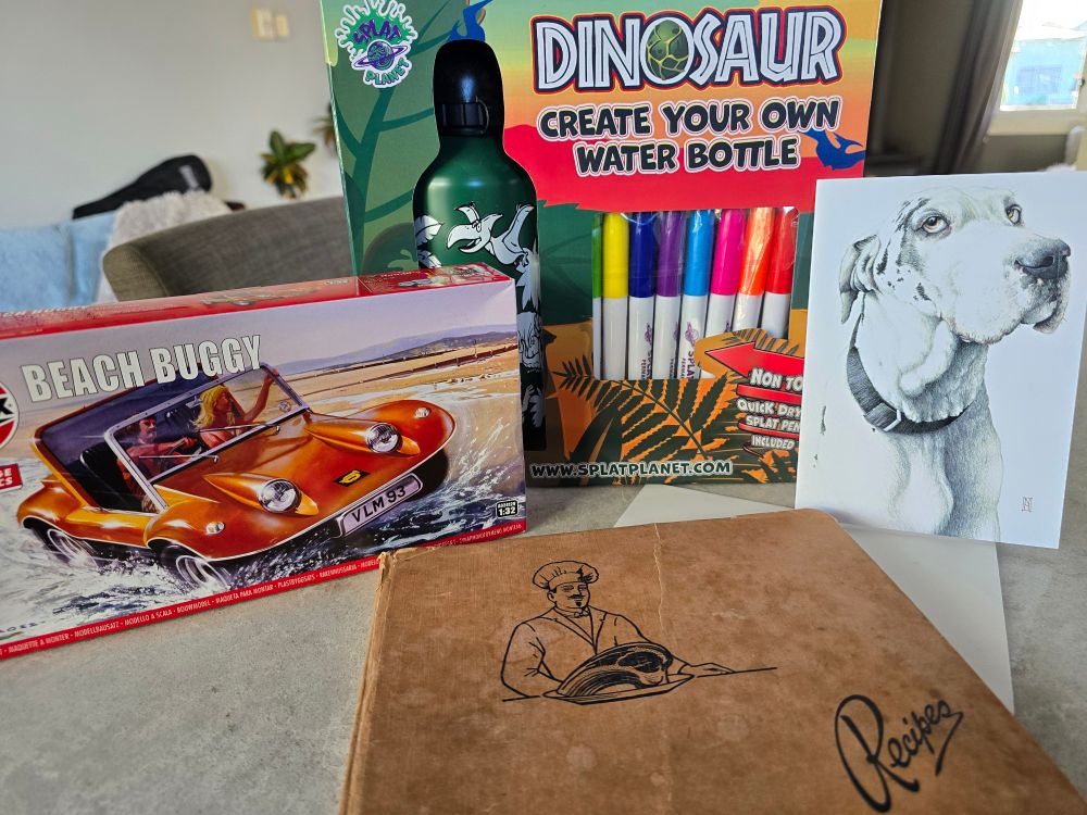 An airfix model of a beach buggy to build, a waterbottle with dinosaurs representing the t rex and a beautiful  card with a beautiful great dane by wildhoneyart.co.nz  plus an amazing find of an old recipe book with handwritten recipes inside😀 