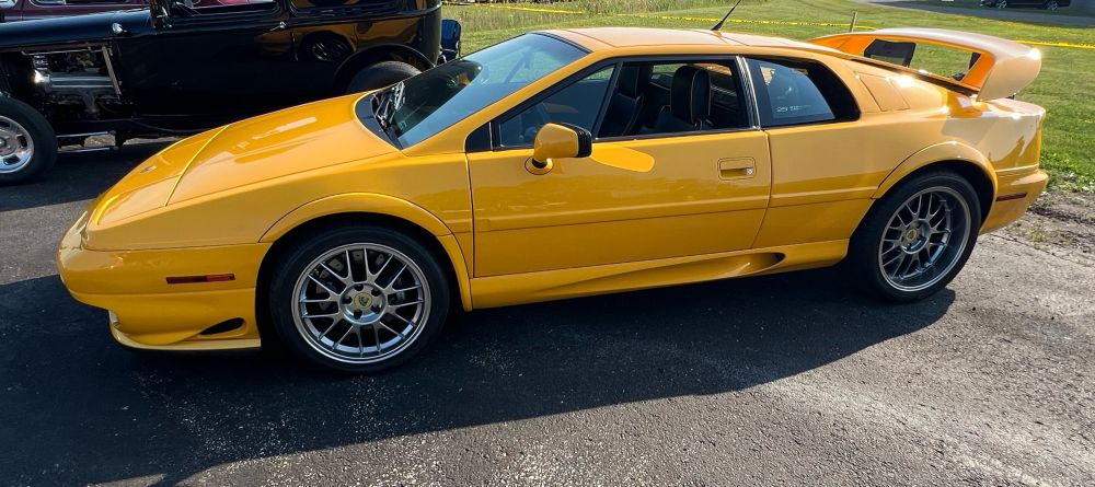 Bright yellow Lotus Esprit showing the left side