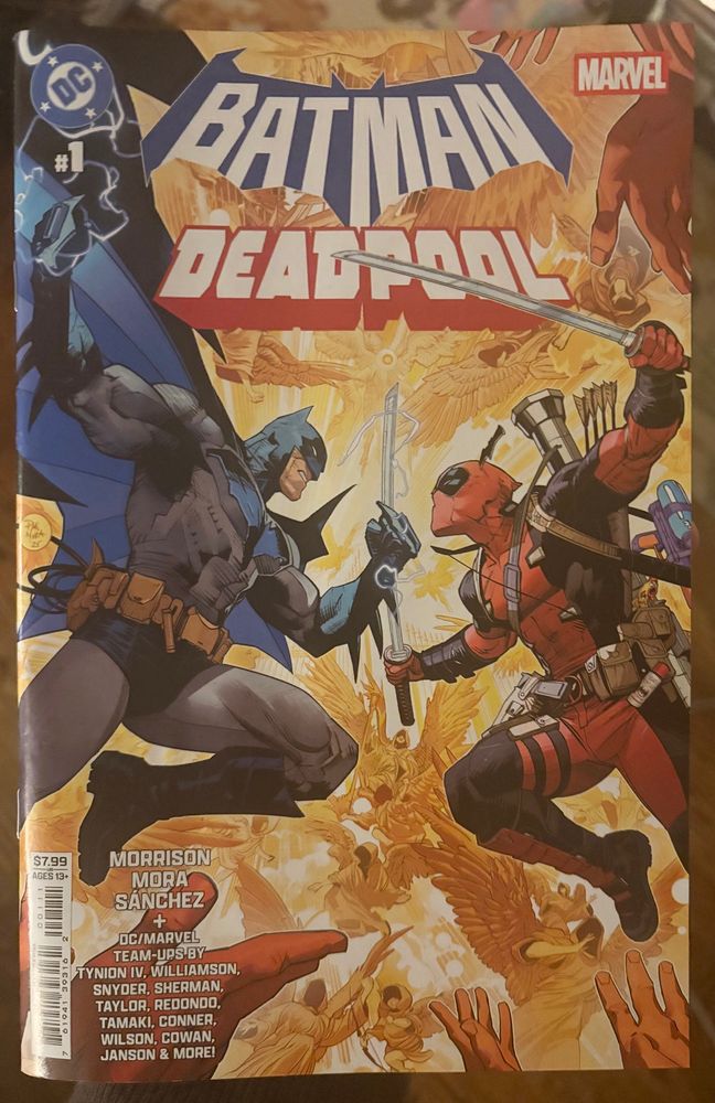 Batman/Deadpool #1. The cover by Dan Mora shows the two leaping towards each other about to fight.