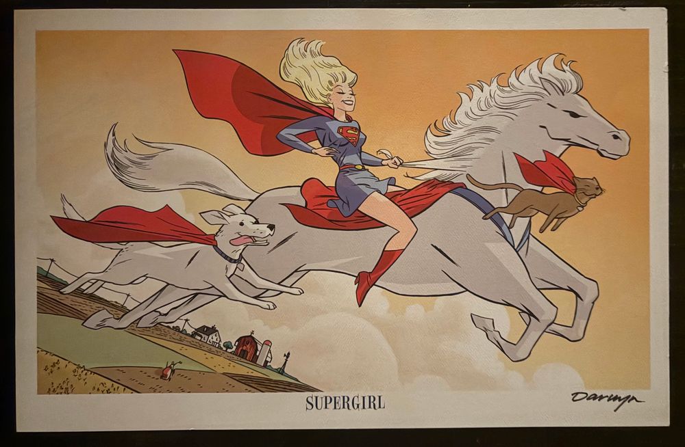 Supergirl riding Comet the Super-Horse in the air as Krypto and Streaky fly next to them. We can see farmland below.